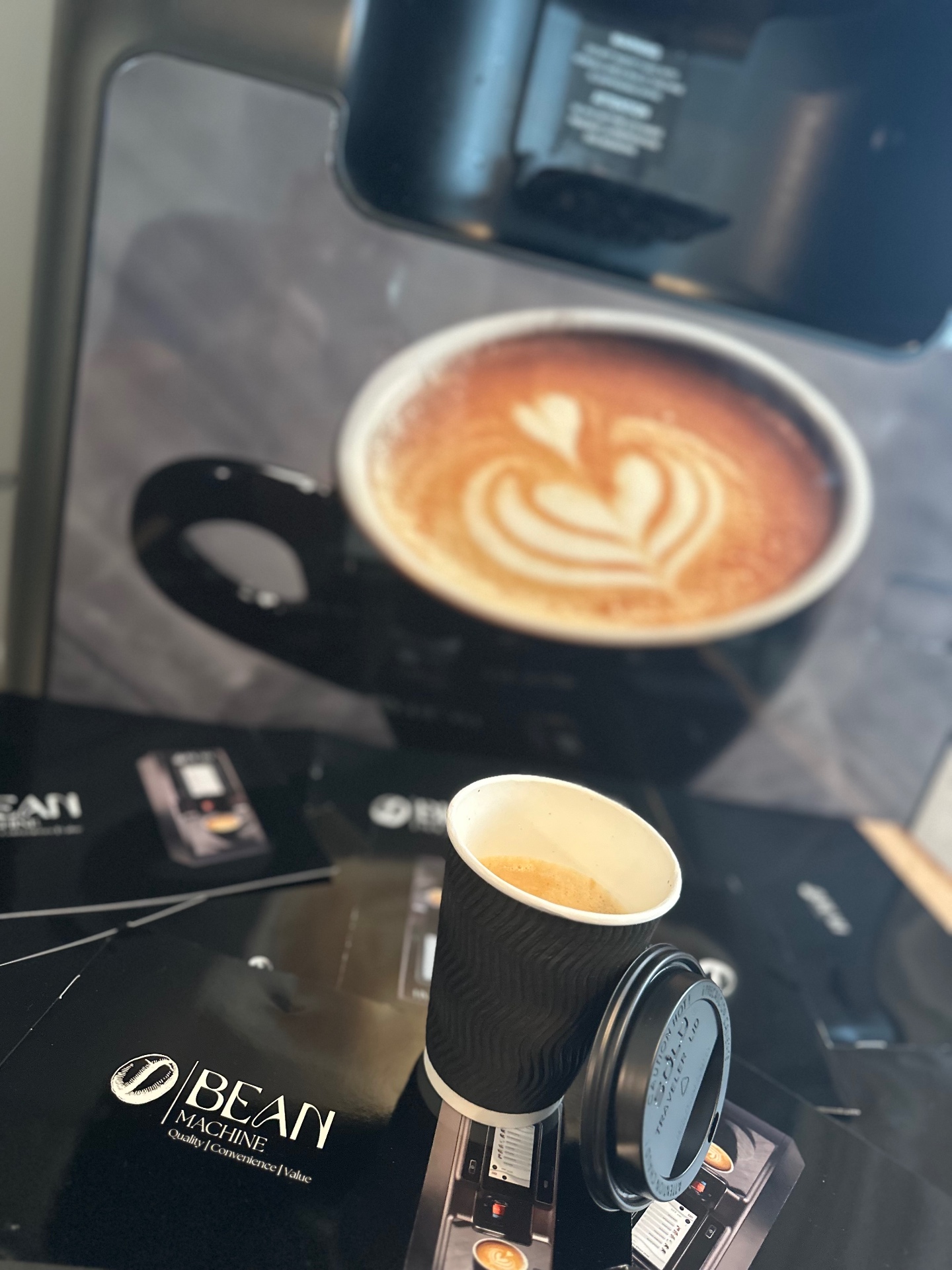 An espresso cup with Bean Machine brochures
